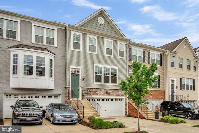 6911 Stansbury Ln, Landover, MD 20785 - multi unit property featuring an attached garage, concrete driveway, and stairs