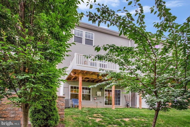 6911 Stansbury Ln, Landover, MD 20785 - rear view of house featuring a lawn, a balcony, and central AC unit