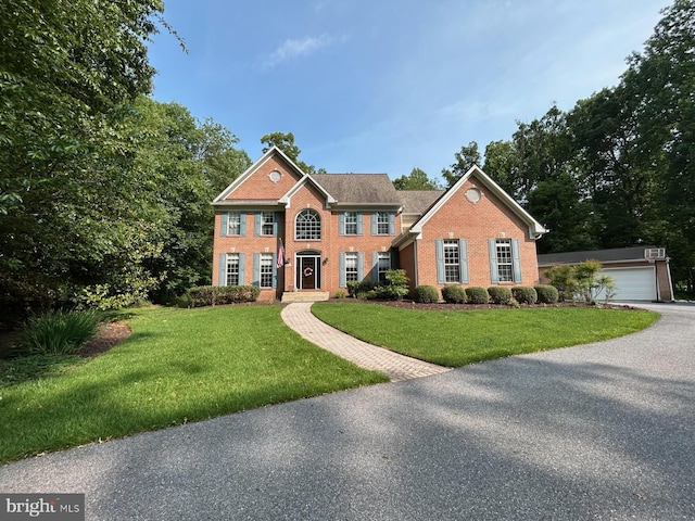 3302 Sang Rd, Glenwood, MD 21738 - colonial home with brick siding, a front yard, and an outdoor structure