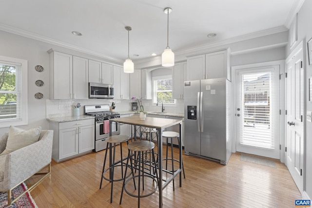 1012 Locust Ln, Charlottesville, VA 22901 - kitchen featuring stainless steel appliances, a sink, light wood finished floors, backsplash, and ornamental molding