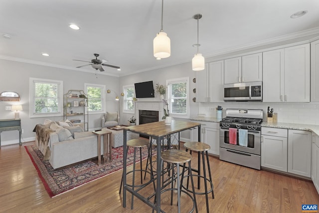1012 Locust Ln, Charlottesville, VA 22901 - kitchen with stainless steel appliances, light wood-type flooring, backsplash, ceiling fan, and crown molding
