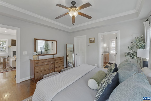 1012 Locust Ln, Charlottesville, VA 22901 - bedroom featuring hardwood / wood-style floors, a tray ceiling, baseboards, ornamental molding, and ceiling fan