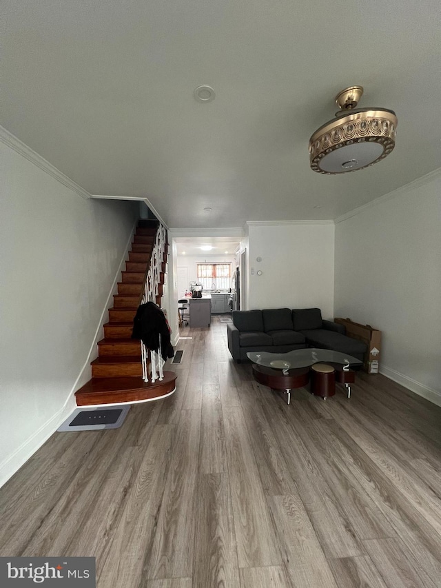 1719 S Chadwick St, Philadelphia, PA 19145 - living room with ornamental molding, wood finished floors, stairs, and baseboards