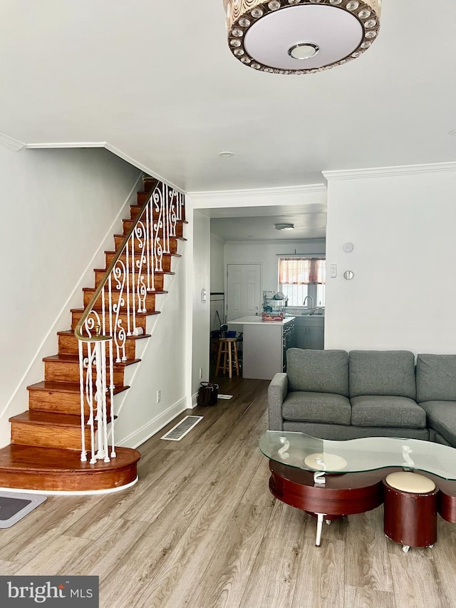 1719 S Chadwick St, Philadelphia, PA 19145 - living area with wood finished floors, crown molding, stairway, and baseboards