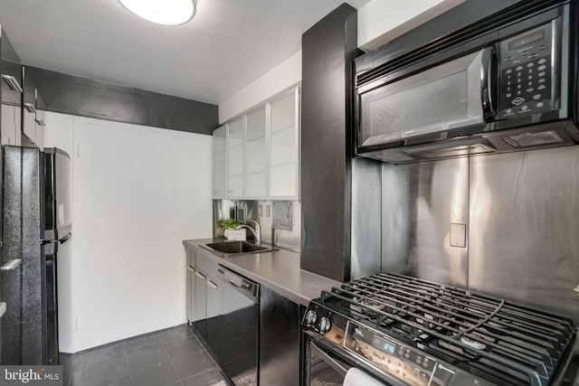 6631 Wakefield Dr Unit 209, Alexandria, VA 22307 - kitchen featuring black appliances, a sink, white cabinets, and dark tile patterned floors