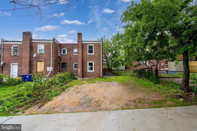 821 E Jeffrey St, Baltimore, MD 21225 - view of front of home featuring brick siding and a chimney