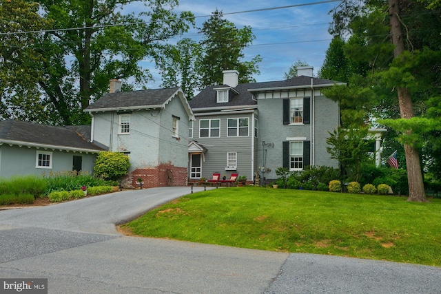 417 E Washington St, Charles Town, WV 25414 - view of front of house with a front yard, a chimney, and asphalt driveway