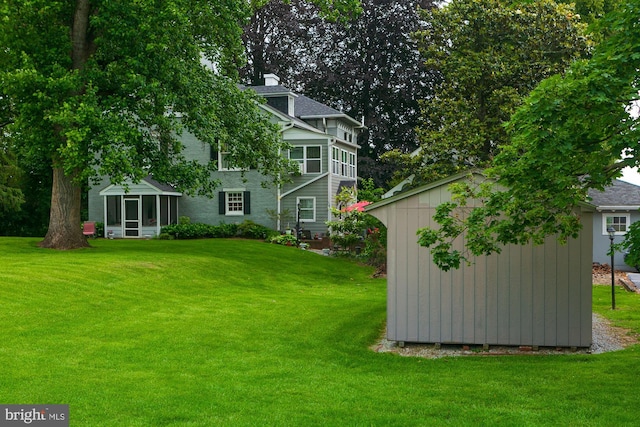 417 E Washington St, Charles Town, WV 25414 - view of grassy yard with a sunroom and a storage unit