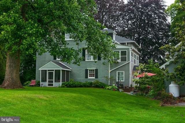 417 E Washington St, Charles Town, WV 25414 - back of house featuring a sunroom and a lawn