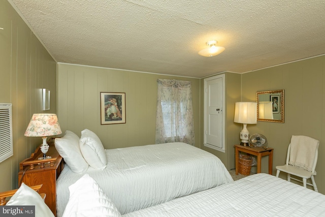 417 E Washington St, Charles Town, WV 25414 - bedroom featuring a textured ceiling and a decorative wall