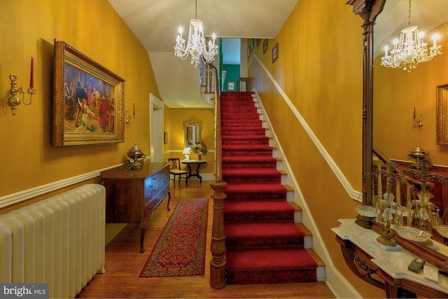 417 E Washington St, Charles Town, WV 25414 - stairs with radiator, a chandelier, and wood finished floors