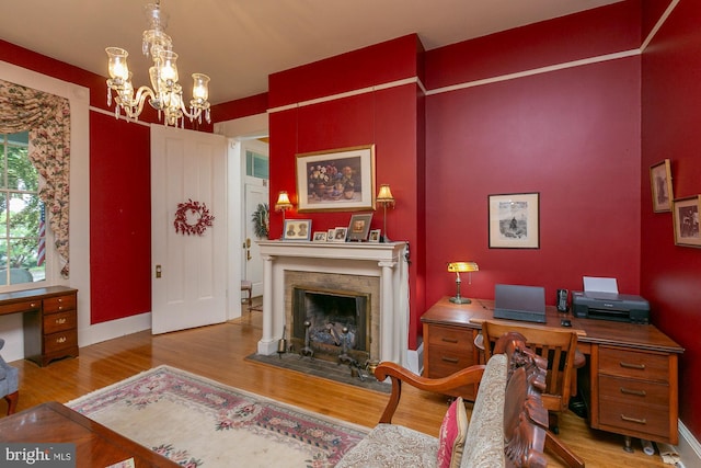 417 E Washington St, Charles Town, WV 25414 - office with wood finished floors, a fireplace with flush hearth, and a chandelier