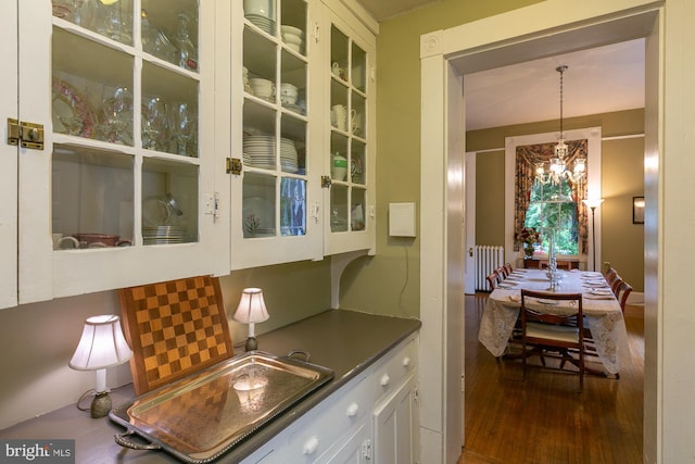 417 E Washington St, Charles Town, WV 25414 - kitchen featuring radiator, dark countertops, wood finished floors, a chandelier, and decorative light fixtures