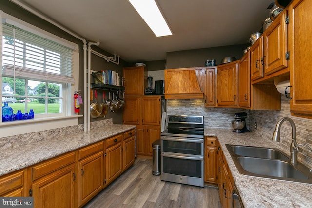 417 E Washington St, Charles Town, WV 25414 - kitchen with range with two ovens, custom range hood, brown cabinets, and light countertops
