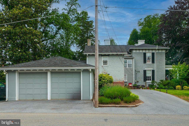 417 E Washington St, Charles Town, WV 25414 - view of front of house featuring a chimney, a detached garage, and an outdoor structure