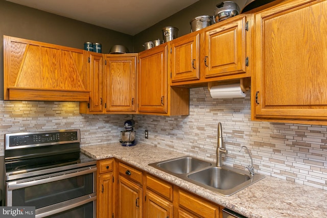 417 E Washington St, Charles Town, WV 25414 - kitchen with double oven range, light countertops, tasteful backsplash, premium range hood, and brown cabinets