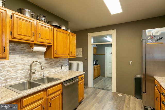 417 E Washington St, Charles Town, WV 25414 - kitchen featuring stainless steel appliances, radiator, light wood-style floors, and light countertops