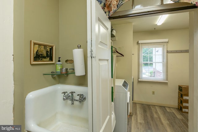 417 E Washington St, Charles Town, WV 25414 - full bathroom featuring washer / dryer, wood finished floors, and a tub