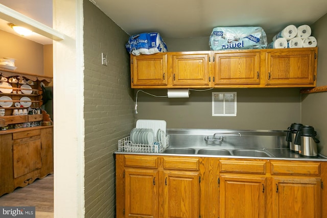 417 E Washington St, Charles Town, WV 25414 - kitchen with light wood-style flooring, light countertops, and brown cabinetry