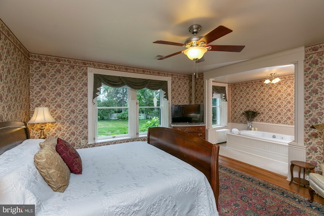 417 E Washington St, Charles Town, WV 25414 - bedroom featuring wallpapered walls, wood finished floors, radiator, and ceiling fan