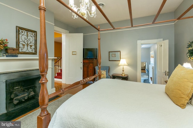 417 E Washington St, Charles Town, WV 25414 - bedroom with a fireplace and a chandelier