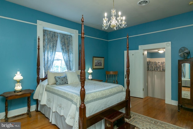 417 E Washington St, Charles Town, WV 25414 - bedroom with a chandelier, wood finished floors, and radiator