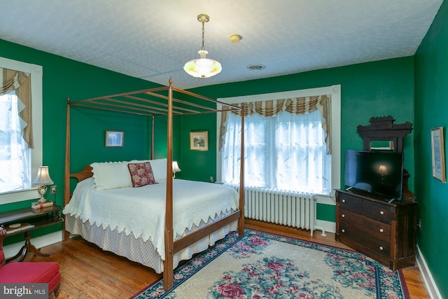 417 E Washington St, Charles Town, WV 25414 - bedroom with radiator heating unit and wood finished floors