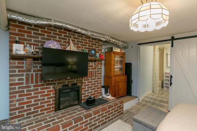 417 E Washington St, Charles Town, WV 25414 - living area featuring a barn door, a textured ceiling, and wood finished floors