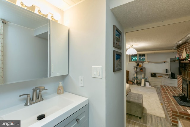 417 E Washington St, Charles Town, WV 25414 - bathroom with vanity, a textured ceiling, and wood finished floors