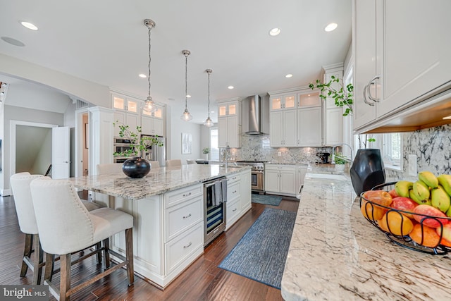 6513 Manor Ridge Ct, Falls Church, VA 22043 - kitchen featuring wall chimney range hood, wine cooler, stainless steel appliances, a sink, and white cabinets