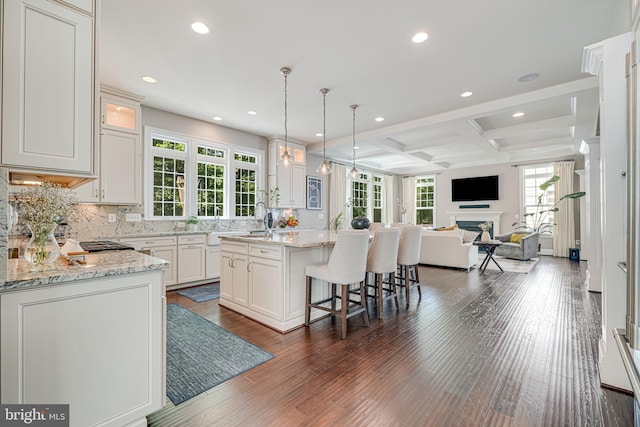 6513 Manor Ridge Ct, Falls Church, VA 22043 - kitchen with plenty of natural light, a kitchen island with sink, open floor plan, coffered ceiling, and recessed lighting