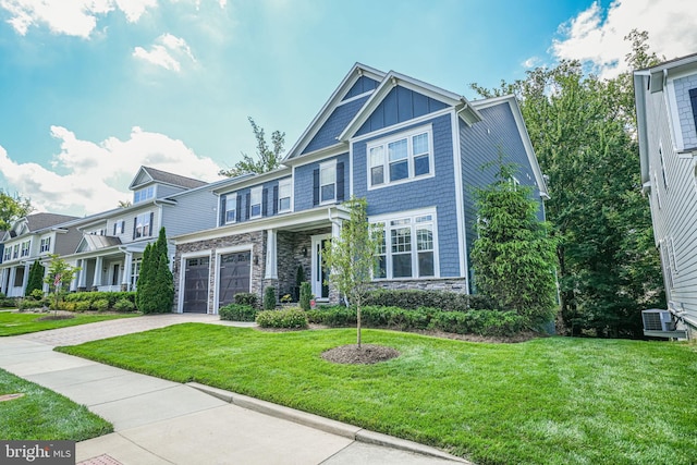 6513 Manor Ridge Ct, Falls Church, VA 22043 - view of front of house with stone siding, driveway, an attached garage, board and batten siding, and a front lawn