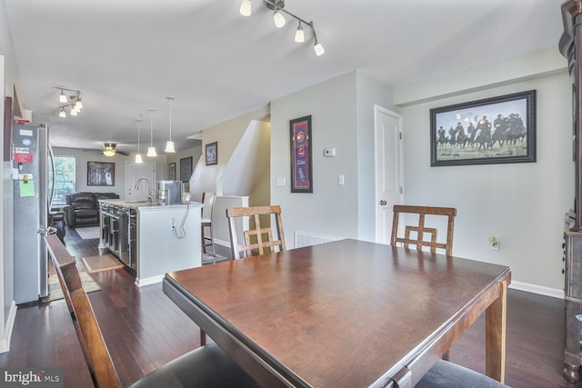 4613 Dillon St, Baltimore, MD 21224 - dining area featuring rail lighting, dark wood finished floors, and a ceiling fan