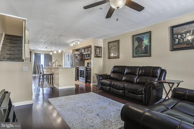 4613 Dillon St, Baltimore, MD 21224 - living room with ceiling fan, dark wood-style flooring, stairway, and track lighting