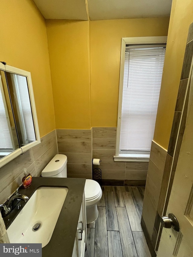 5131 Ludlow St, Philadelphia, PA 19139 - bathroom with toilet, vanity, tile walls, wainscoting, and wood finished floors