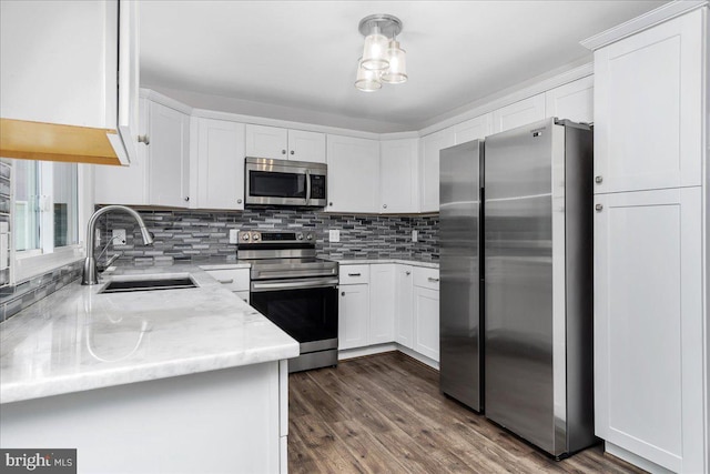 11239 Putman Rd, Thurmont, MD 21788 - kitchen featuring appliances with stainless steel finishes, a sink, backsplash, white cabinets, and light stone counters