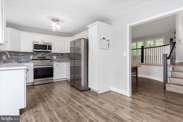 11239 Putman Rd, Thurmont, MD 21788 - kitchen featuring appliances with stainless steel finishes, light countertops, backsplash, and wood finished floors