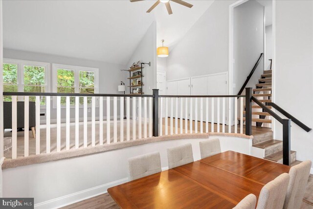 11239 Putman Rd, Thurmont, MD 21788 - dining room featuring ceiling fan, stairway, wood finished floors, high vaulted ceiling, and baseboards