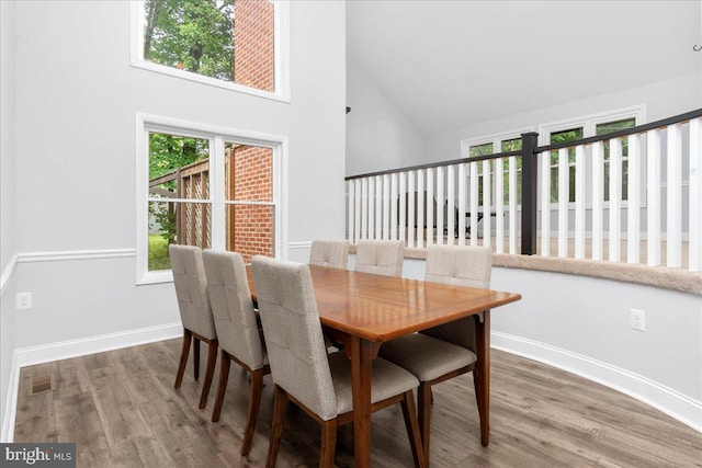 11239 Putman Rd, Thurmont, MD 21788 - dining area with high vaulted ceiling, wood finished floors, and baseboards