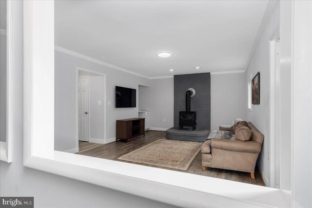 11239 Putman Rd, Thurmont, MD 21788 - living area with ornamental molding, wood finished floors, a wood stove, baseboards, and recessed lighting