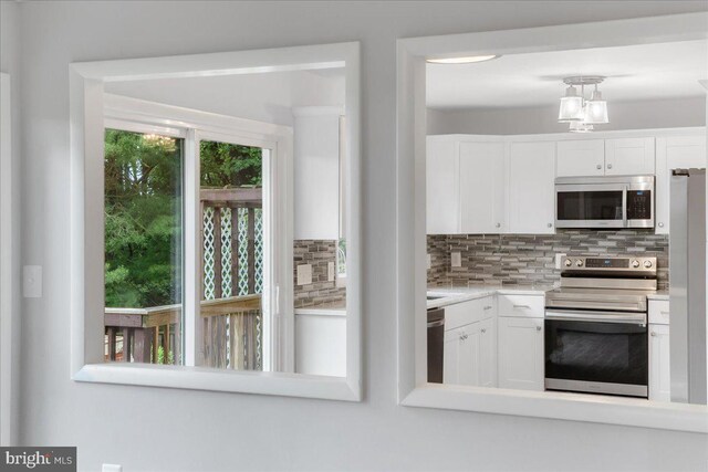 11239 Putman Rd, Thurmont, MD 21788 - kitchen featuring stainless steel appliances, decorative backsplash, white cabinets, and light countertops