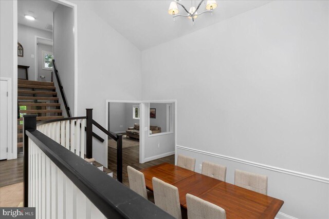 11239 Putman Rd, Thurmont, MD 21788 - stairs with a chandelier, wood finished floors, baseboards, and high vaulted ceiling