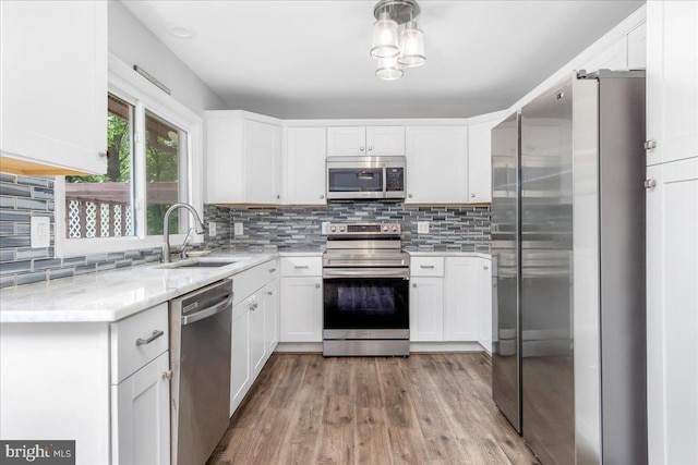 11239 Putman Rd, Thurmont, MD 21788 - kitchen featuring appliances with stainless steel finishes, a sink, white cabinets, and backsplash