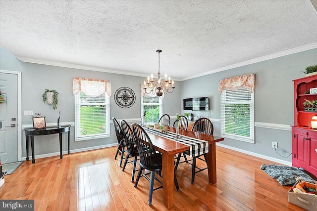 11 Thomas Cir, New Freedom, PA 17349 - dining area with a chandelier, light wood finished floors, a textured ceiling, and crown molding