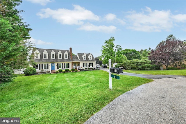 11 Thomas Cir, New Freedom, PA 17349 - cape cod house with a front lawn, driveway, and a chimney