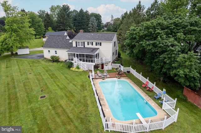 11 Thomas Cir, New Freedom, PA 17349 - rear view of house with a sunroom, a fenced backyard, stairway, a shingled roof, and a chimney