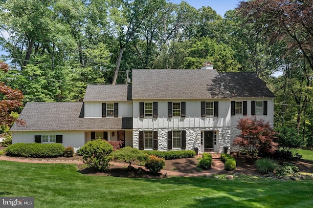661 Timber Ln, Devon, PA 19333 - colonial house with a chimney, a front yard, and a shingled roof