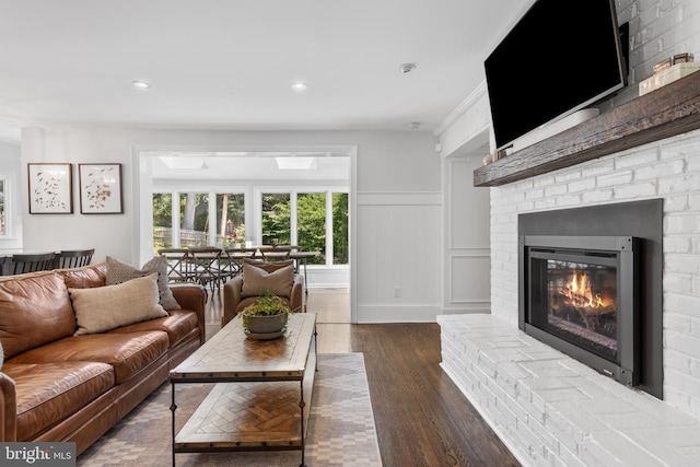 661 Timber Ln, Devon, PA 19333 - living room with a brick fireplace, wood finished floors, wainscoting, a decorative wall, and recessed lighting
