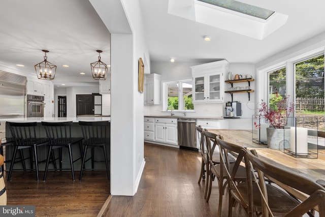 661 Timber Ln, Devon, PA 19333 - dining area with healthy amount of natural light, dark wood-style flooring, recessed lighting, a chandelier, and a skylight