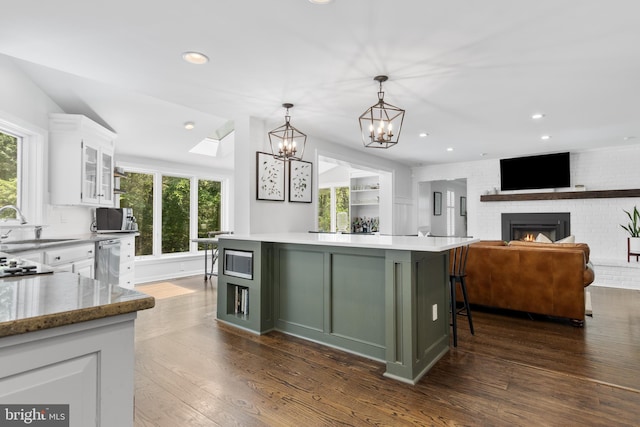 661 Timber Ln, Devon, PA 19333 - kitchen with dark wood-type flooring, white cabinetry, a kitchen island, plenty of natural light, and recessed lighting